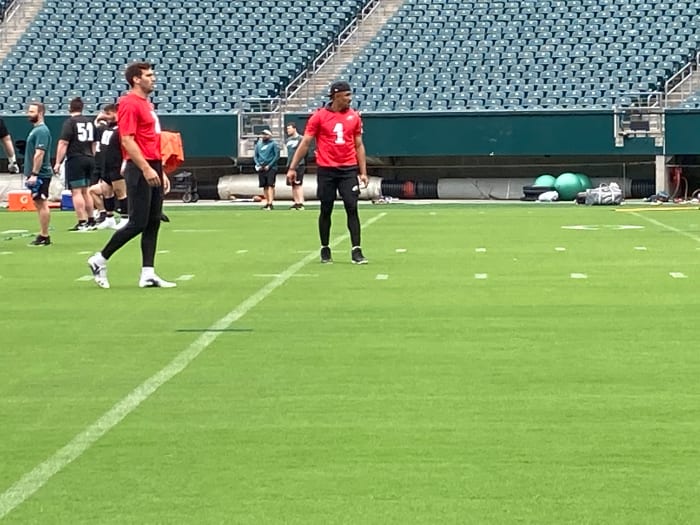 Eagles QBs Joe Flacco (left) and Jalen Hurts warm up prior to practice on June 4, 2021